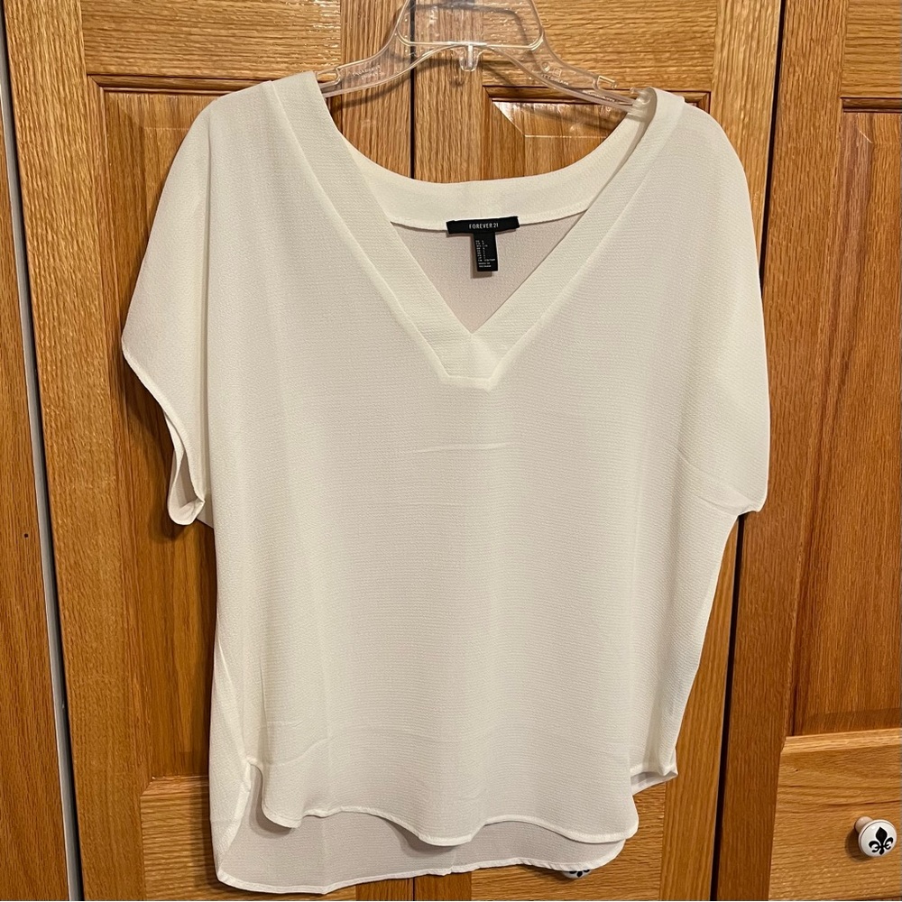 Forever 21 ivory blouse. Size L V neck, short sleeve. Slightly rounded…